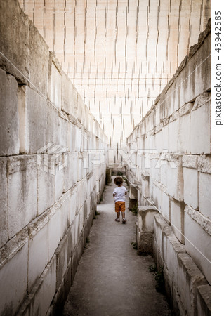 Lonely young boy walking in a corridor 43942585