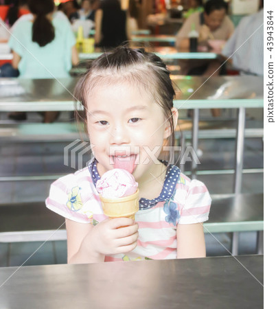 Cute little asia girl smile and eating ice-cream Cute little asia girl smile and eating ice-cream 43943844