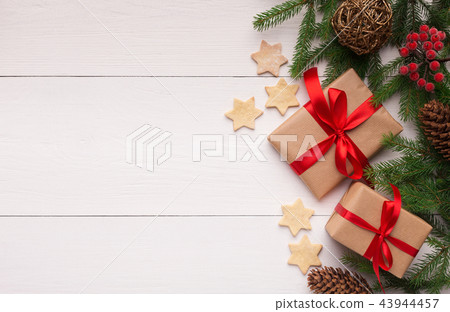 Composition with Christmas gift box and fir tree branch Composition with Christmas gift box and fir tree branch 43944457