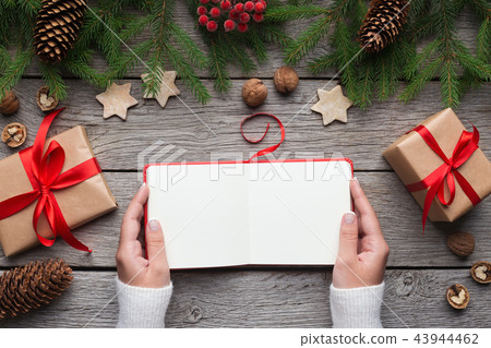 Girl reading blank book during christmas holidays Girl reading blank book during christmas holidays 43944462