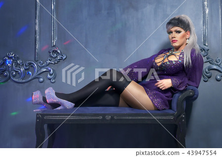 travesty-diva. The concept of a transvestite. Man-actor turns into a woman. he is posing for the 43947554