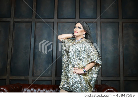 travesty-diva. The concept of a transvestite. Man-actor turns into a woman. he is posing for the 43947599