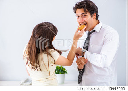 Woman sees her husband off to work Woman sees her husband off to work 43947663
