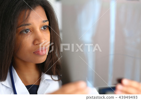 Female black doctor hold in arm and look Female black doctor hold in arm and look 43949493