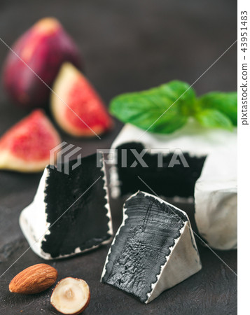 Unusual black camembert cheese with white mildew 43951483