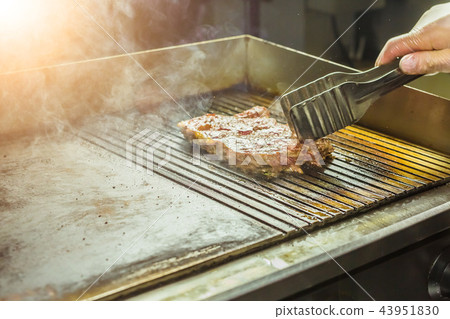 Food and cooking concept - Close up of a steak on grill Food and cooking concept - Close up of a steak on grill 43951830