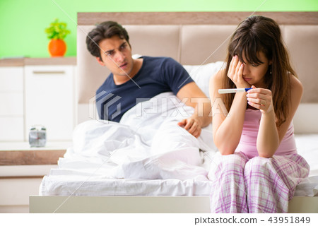 Young married woman with pregnancy results test 43951849