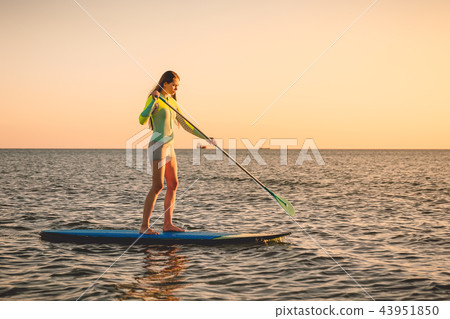 Sporty woman floating at stand up paddle board 43951850