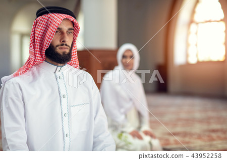 Muslim Praying man and woman in mosque 43952258