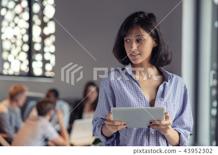 Portrait of smiling woman in office with tablet 43952302
