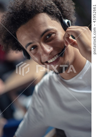 Laughing african american hipster software developer at computer at office of startup company 43952661
