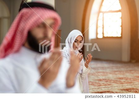 Muslim Praying man and woman in mosque Muslim Praying man and woman in mosque 43952811