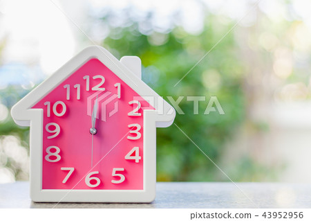 Pink clock with home shape at 12 o'clock Pink clock with home shape at 12 o'clock 43952956