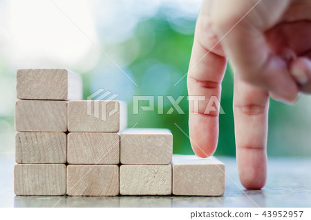 Fingers moving step up the wooden toy staircase Fingers moving step up the wooden toy staircase 43952957