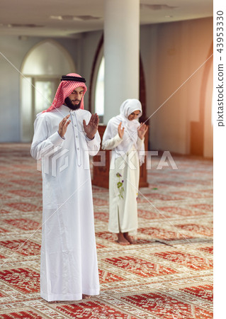 Muslim Praying man and woman in mosque Muslim Praying man and woman in mosque 43953330