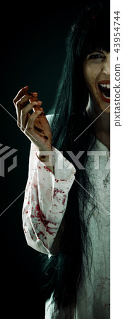 Crazy bloody scary zombie woman screams at camera 43954744