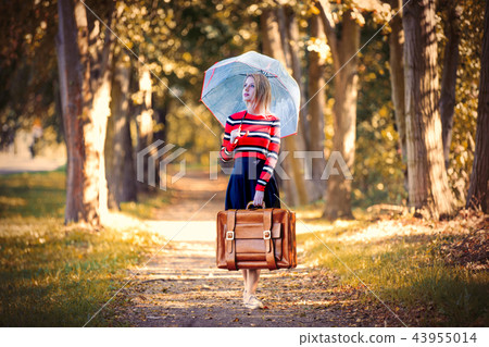 girl with umbrella and suitcase in autumn park girl with umbrella and suitcase in autumn park 43955014