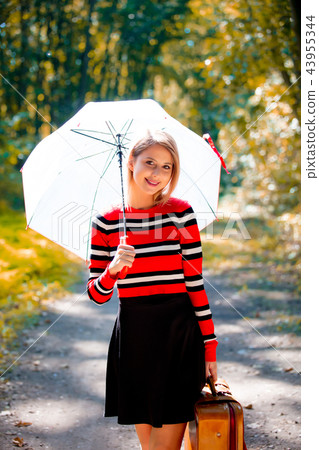 girl with umbrella and suitcase in autumn park girl with umbrella and suitcase in autumn park 43955344