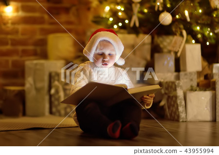Little boy reading a magic book in living room 43955994