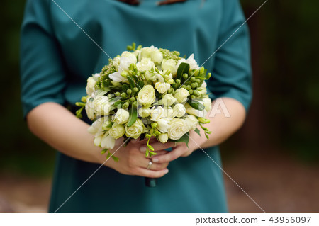 Bride or bridesmaid holding wedding flowers 43956097