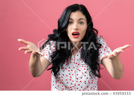 Young woman shrugging Young woman shrugging 43959333