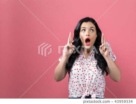 Young woman wishing for good luck Young woman wishing for good luck 43959334