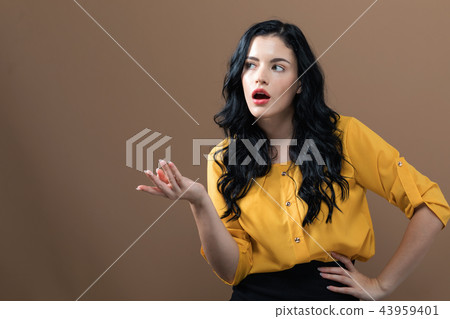 Young woman shrugging Young woman shrugging 43959401