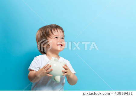 Toddler boy with a piggy bank Toddler boy with a piggy bank 43959431