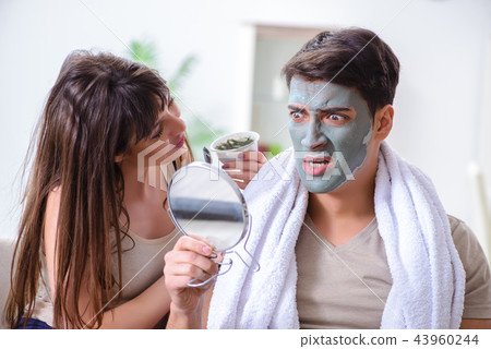 Handsome applying clay mask on face 43960244