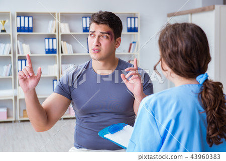 Young man visiting female traumatologist with black eye Young man visiting female traumatologist with black eye 43960383