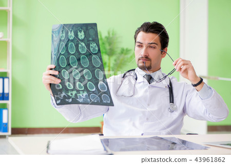 Doctor radiologist looking at x-ray scan in hospital Doctor radiologist looking at x-ray scan in hospital 43961862