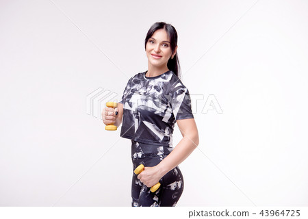 Beautiful athletic woman wearing in sports style clothing makes sports exercis . Beautiful athletic woman wearing in sports style clothing makes sports exercis . 43964725