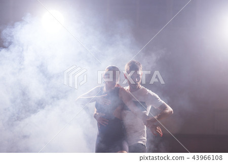 Active happy adults dancing bachata together in dance class 43966108