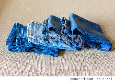 Stack of blue jeans.Shades of denim fabric. Stack of blue jeans.Shades of denim fabric. 43968361