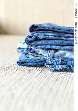 Stack of blue jeans.Shades of denim fabric. Stack of blue jeans.Shades of denim fabric. 43968367