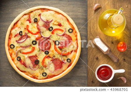 pizza and food ingredients at wooden table 43968701