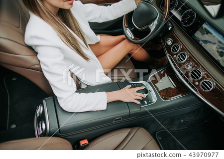 Lady arm pushing button in modern car Lady arm pushing button in modern car 43970977