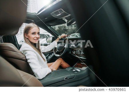 Happy girl situating in the cozy car 43970981