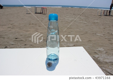 Sandy beach and a bottle of lamb Sandy beach and a bottle of lamb 43971168