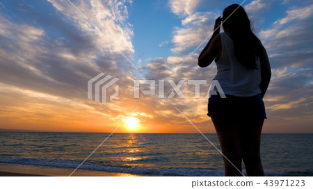 Woman relaxing at the sea admiring the sunset 43971223