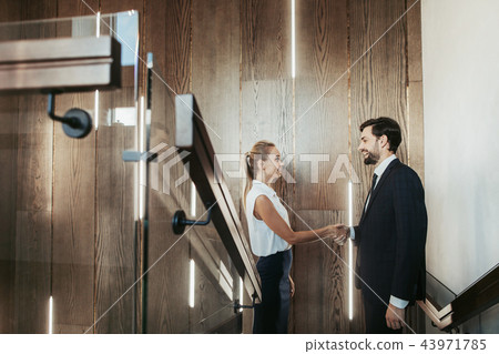 Happy girl greeting with outgoing female indoor Happy girl greeting with outgoing female indoor 43971785