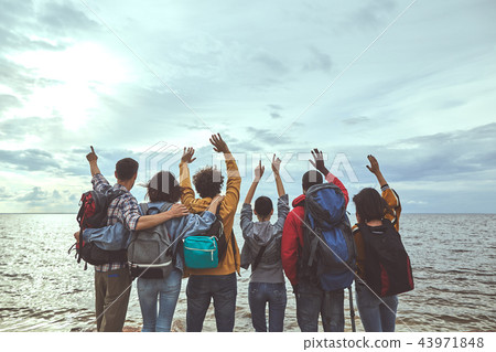 Group of people jumping with their hands up 43971848