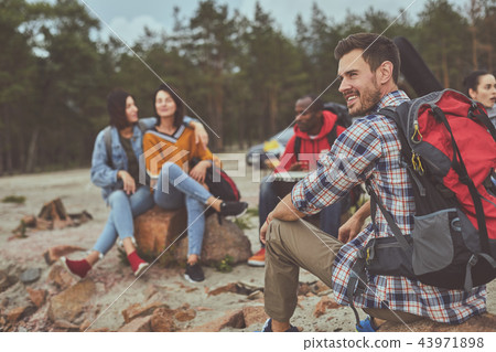 Smile man sitting with his friends outdoor 43971898