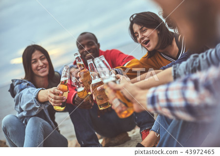 Happy friends talking during party on the beach 43972465