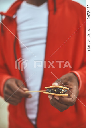 Adult man is holding cookies with chocolate Adult man is holding cookies with chocolate 43972485