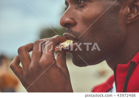 Adult man is holding crackers with chocolate Adult man is holding crackers with chocolate 43972486