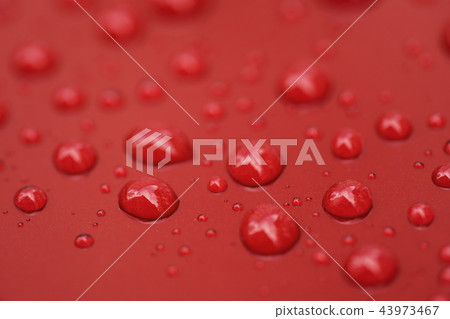 Closeup rain drops on red car with hydrophobic coating 43973467