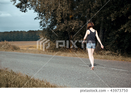 young girl posing on the country road and field young girl posing on the country road and field 43973750