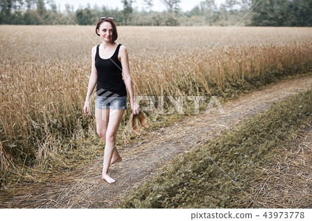 young girl posing on the country road and field young girl posing on the country road and field 43973778