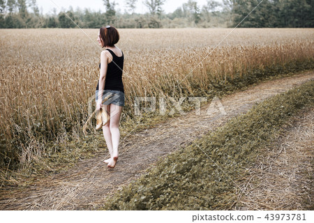 young girl posing on the country road and field young girl posing on the country road and field 43973781